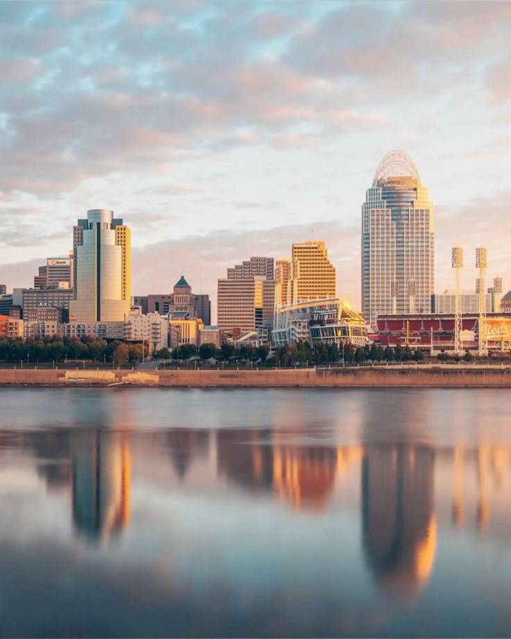 The Cincinnati skyline reflected on the Ohio River at sunrise